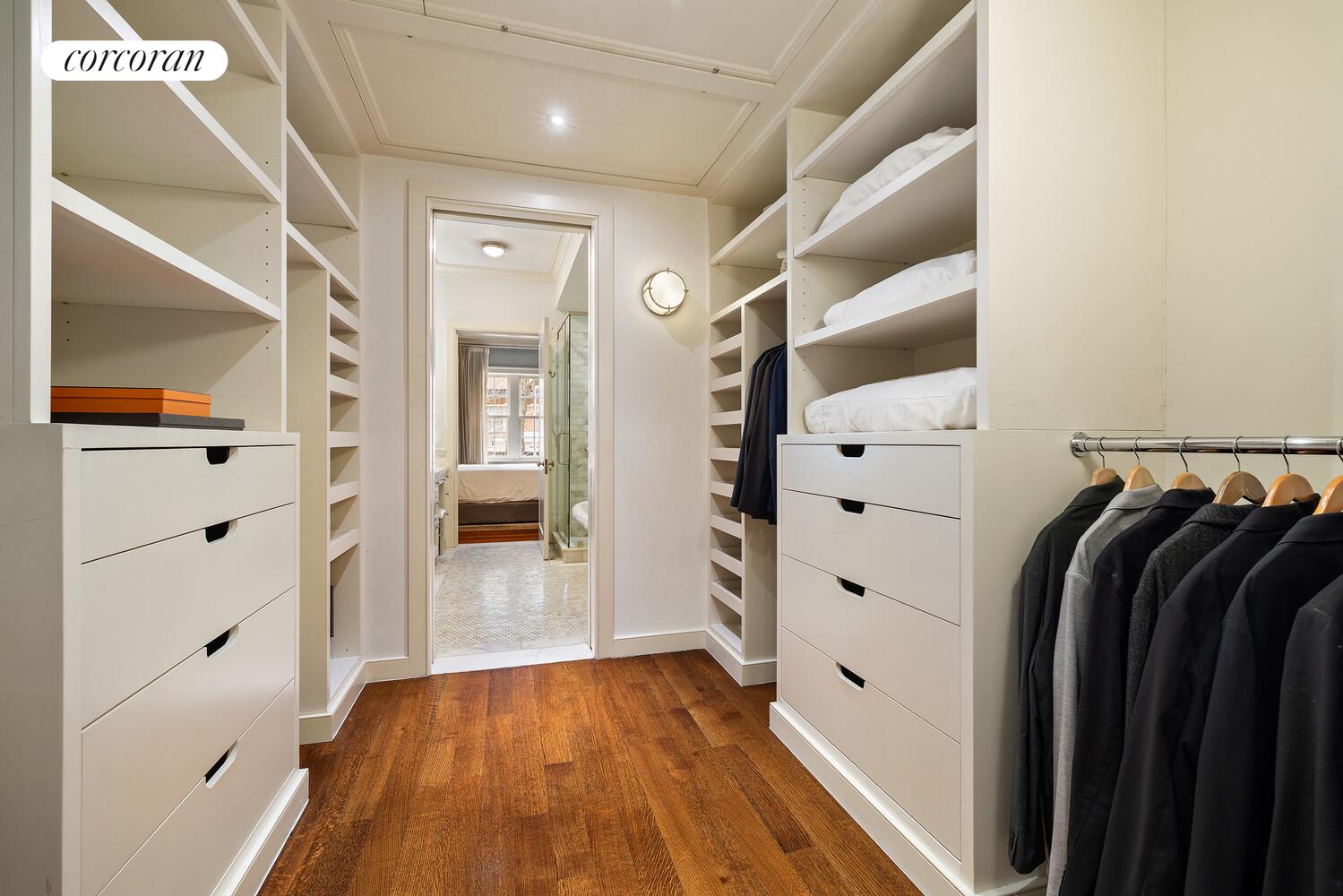435 East 87th Street Manhattan, NY 10128 - Photo 22 of 36 a view of walk in closet with clothes and shoes