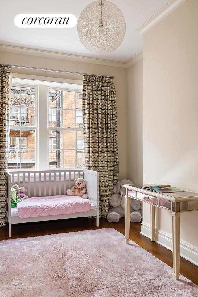 435 East 87th Street Manhattan, NY 10128 - Photo 26 of 36 a bedroom with a bed and a window