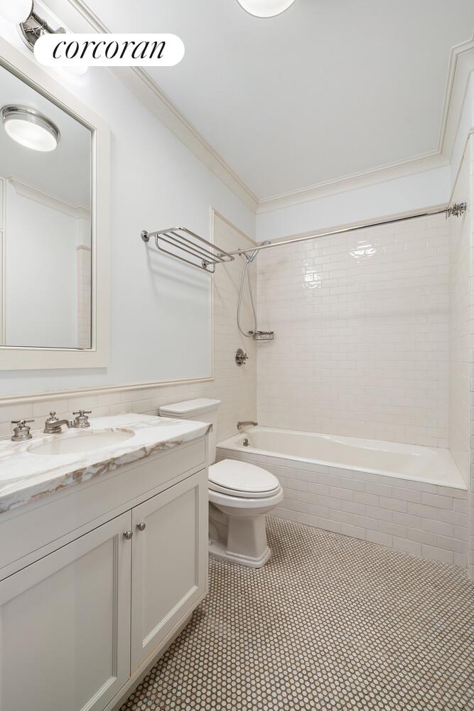 435 East 87th Street Manhattan, NY 10128 - Photo 29 of 36 a bathroom with a sink a toilet and shower