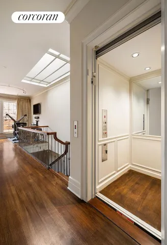 a room with gym equipment and large windows