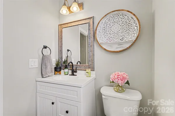 a bathroom with a mirror sink and toilet