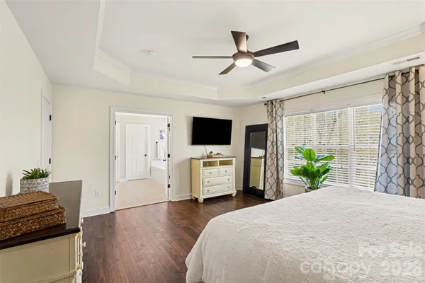 a bedroom with a bed and flat screen tv