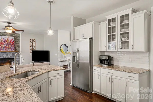 a kitchen with stainless steel appliances granite countertop a refrigerator sink and stove