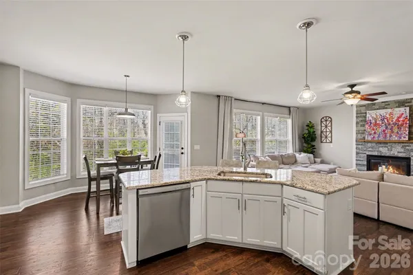 a kitchen with sink cabinets and wooden floor