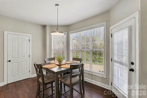 a view of a dining room with furniture window and wooden floor