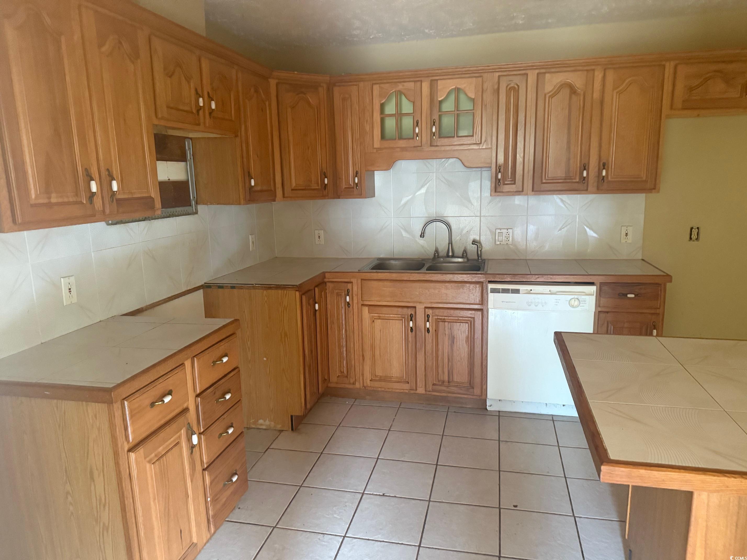 Kitchen with a sink, glass insert cabinets, white