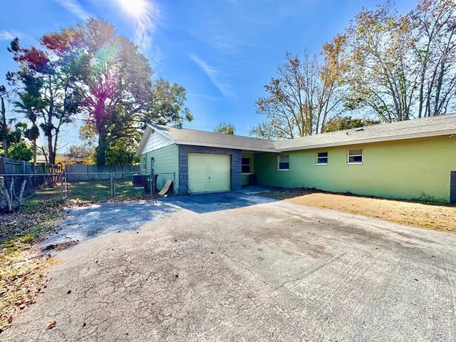 a front view of a house with a yard and a garage