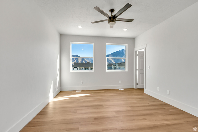 547 North Hvn Drive Mapleton, UT 84664 - Photo 11 of 23 Empty room with light wood finished floors and a ceiling fan
