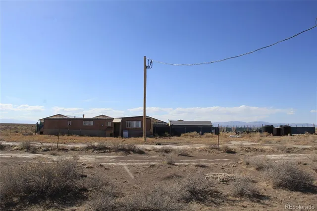 a view of a dry is standing in the middle of a field