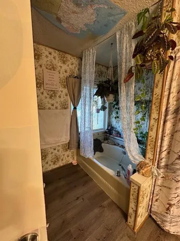 a bedroom with a bed and flat screen tv