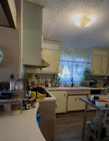 a kitchen with a sink appliances and cabinets