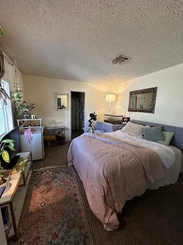 a spacious bedroom with two beds and a window