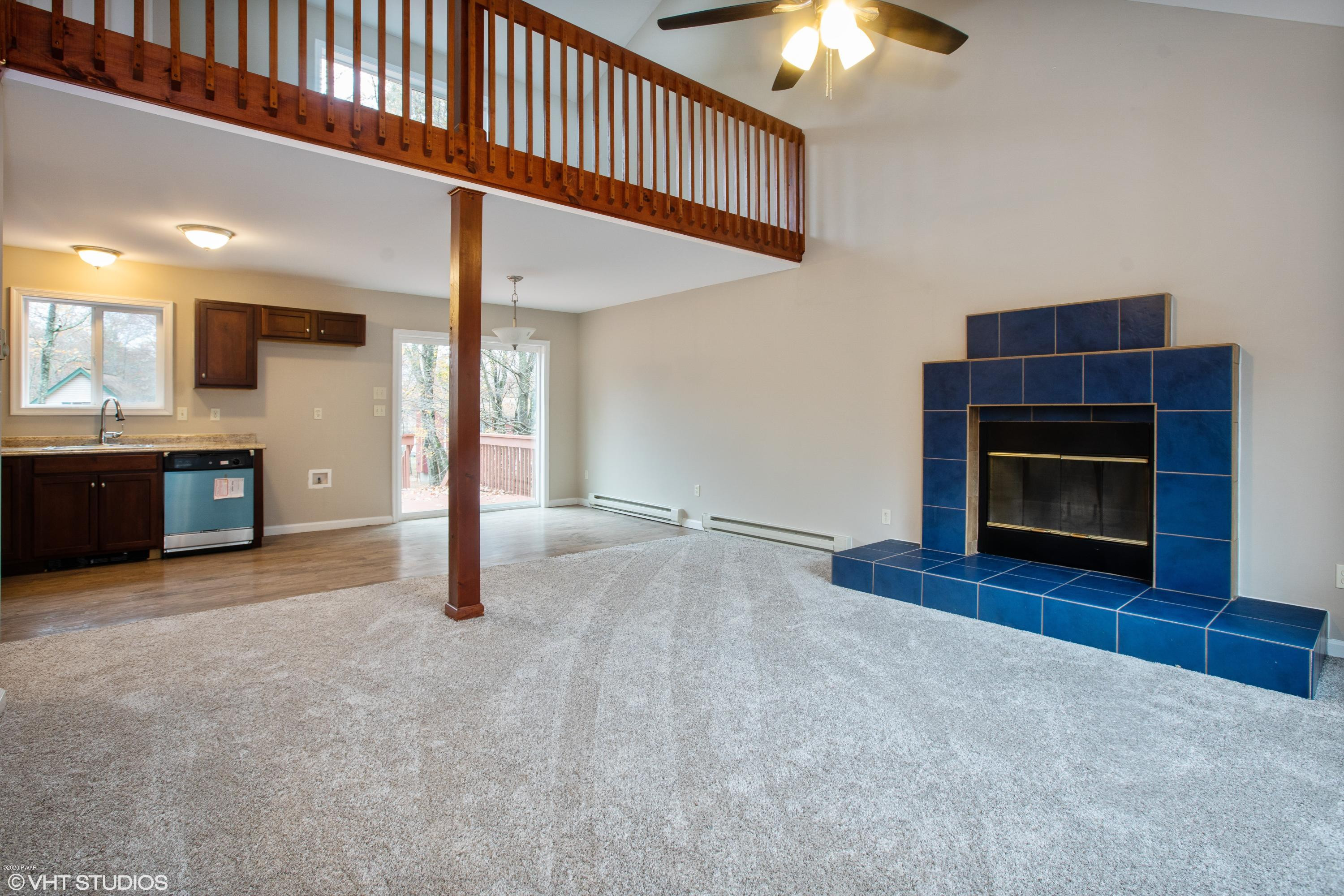 133 Roundhill Road Dingmans Ferry, PA 18328 - Photo 4 of 12 a view of livingroom with furniture and fireplace