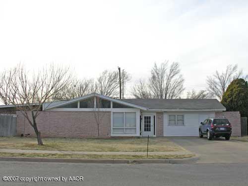 4616 South Bryan Street Amarillo, TX 79110 - Photo 1 of 12 a view of a house with a backyard and garage