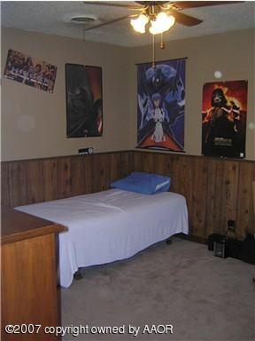 4616 South Bryan Street Amarillo, TX 79110 - Photo 11 of 12 a bedroom with a bed and paintings on the wall