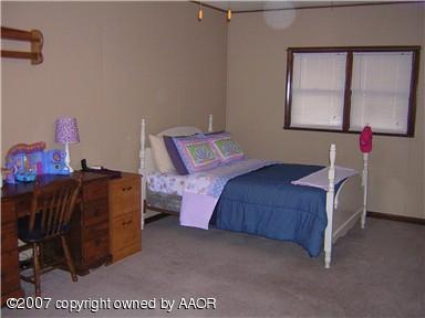 4616 South Bryan Street Amarillo, TX 79110 - Photo 6 of 12 a bedroom with a bed and window