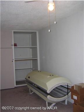 4616 South Bryan Street Amarillo, TX 79110 - Photo 7 of 12 a room with a bed and a cabinets