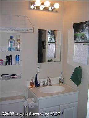 4616 South Bryan Street Amarillo, TX 79110 - Photo 8 of 12 a bathroom with a sink and a mirror