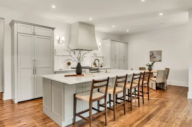 a kitchen with sink stove and wooden floor