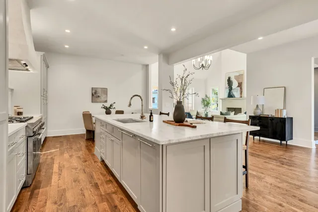 a kitchen with a dining table chairs and stove