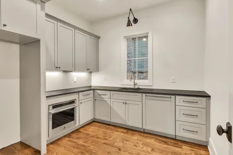 a living room with furniture and floor to ceiling window