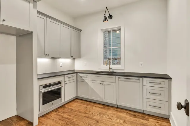 a living room with furniture a fireplace and a large window