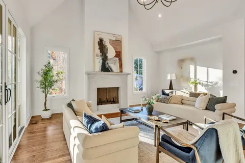 a view of empty room with wooden floor and window