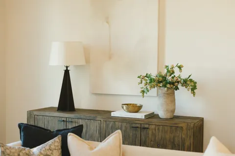 a room with a sink cabinets and a window