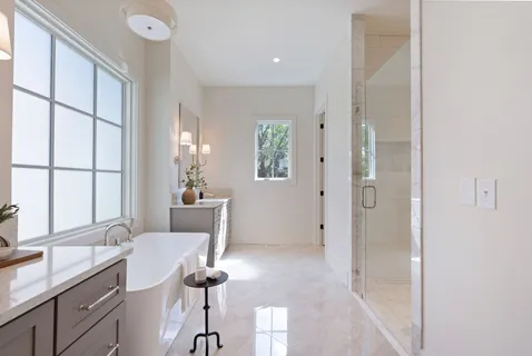 an empty room with windows and ceiling fan