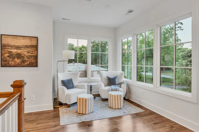an empty room with windows and ceiling fan