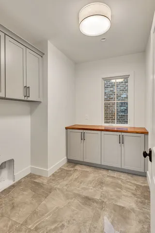 a dining room with furniture a large window and a fireplace