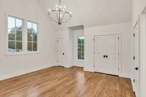 a bedroom with a bed a fireplace and next to a window