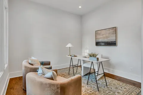 a kitchen with a dining table chairs and stove