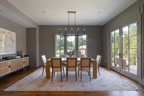 a kitchen with cabinets table and chairs