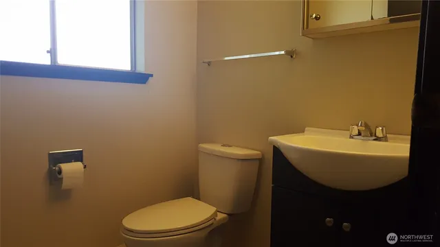 a bathroom with a sink a mirror and a toilet