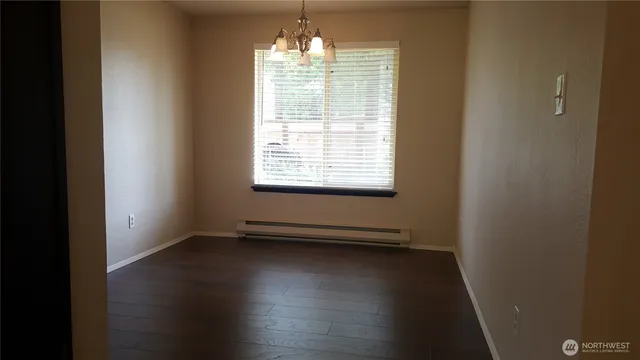 a view of room with window and hardwood floor