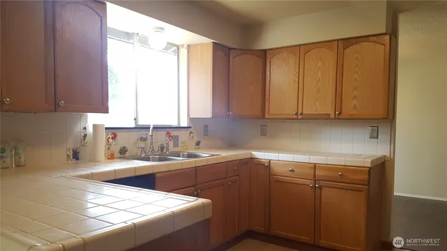 a kitchen with a sink cabinets and window