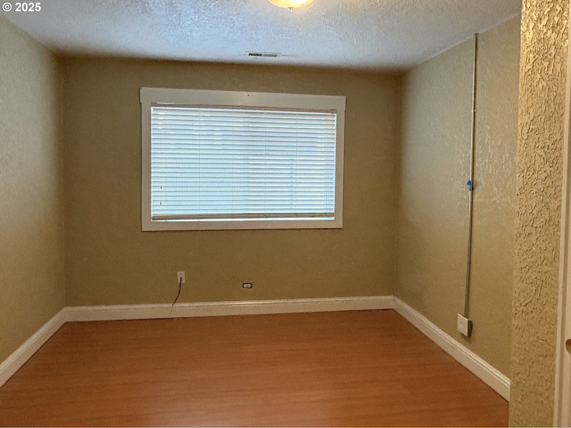 12305 Southwest 7th Street Beaverton, OR 97005 - Photo 11 of 23 a view of a room with wooden floor and a window