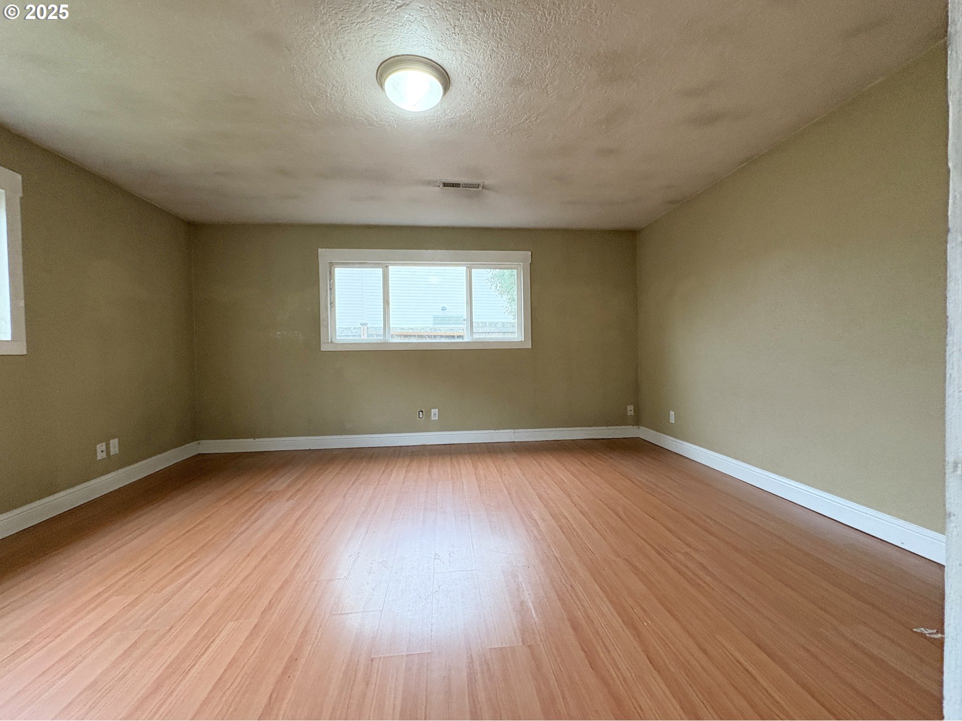 12305 Southwest 7th Street Beaverton, OR 97005 - Photo 14 of 23 an empty room with wooden floor and windows