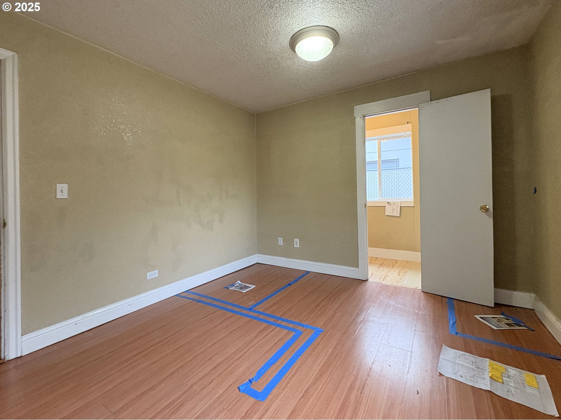 12305 Southwest 7th Street Beaverton, OR 97005 - Photo 15 of 23 an empty room with wooden floor and windows