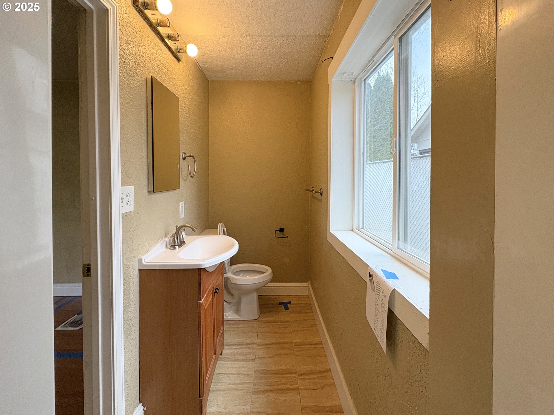 12305 Southwest 7th Street Beaverton, OR 97005 - Photo 16 of 23 a bathroom with a sink and a toilet