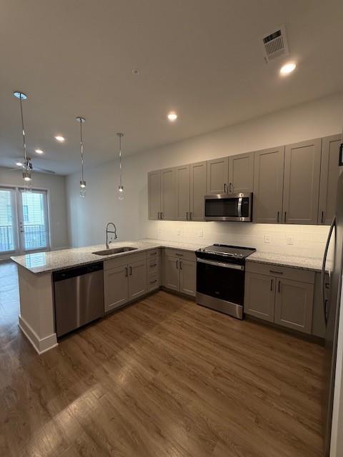 930 Ridgeview Drive, Unit 1262 Allen, TX 75013 - Photo 20 of 28 a large kitchen with stainless steel appliances kitchen island granite countertop a large counter top and wooden floors