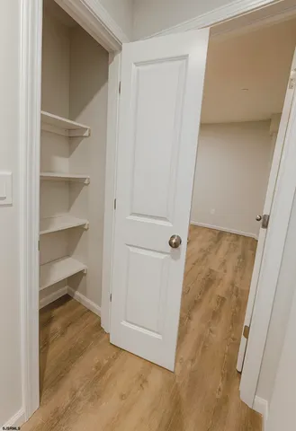 a bedroom with a bed and a night stand