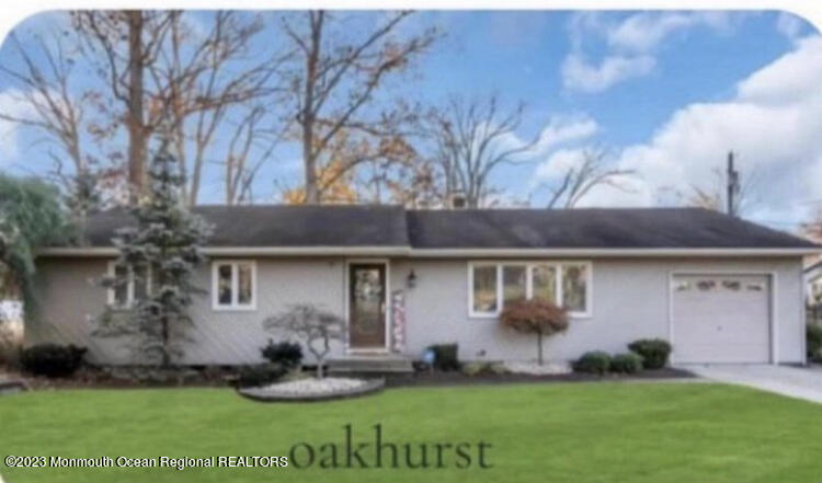 a view of a house with a yard and sitting area