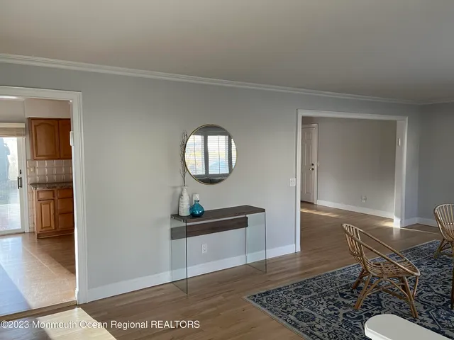 a living room with a mirror and a table