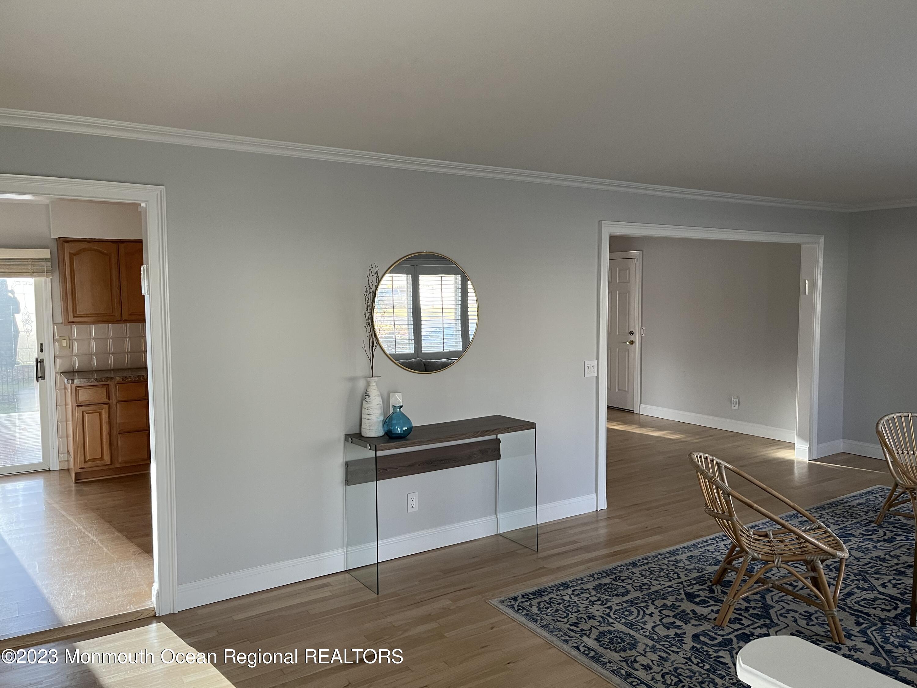 128 Whalepond Road Oakhurst, NJ 07755 - Photo 2 of 11 a living room with a mirror and a table