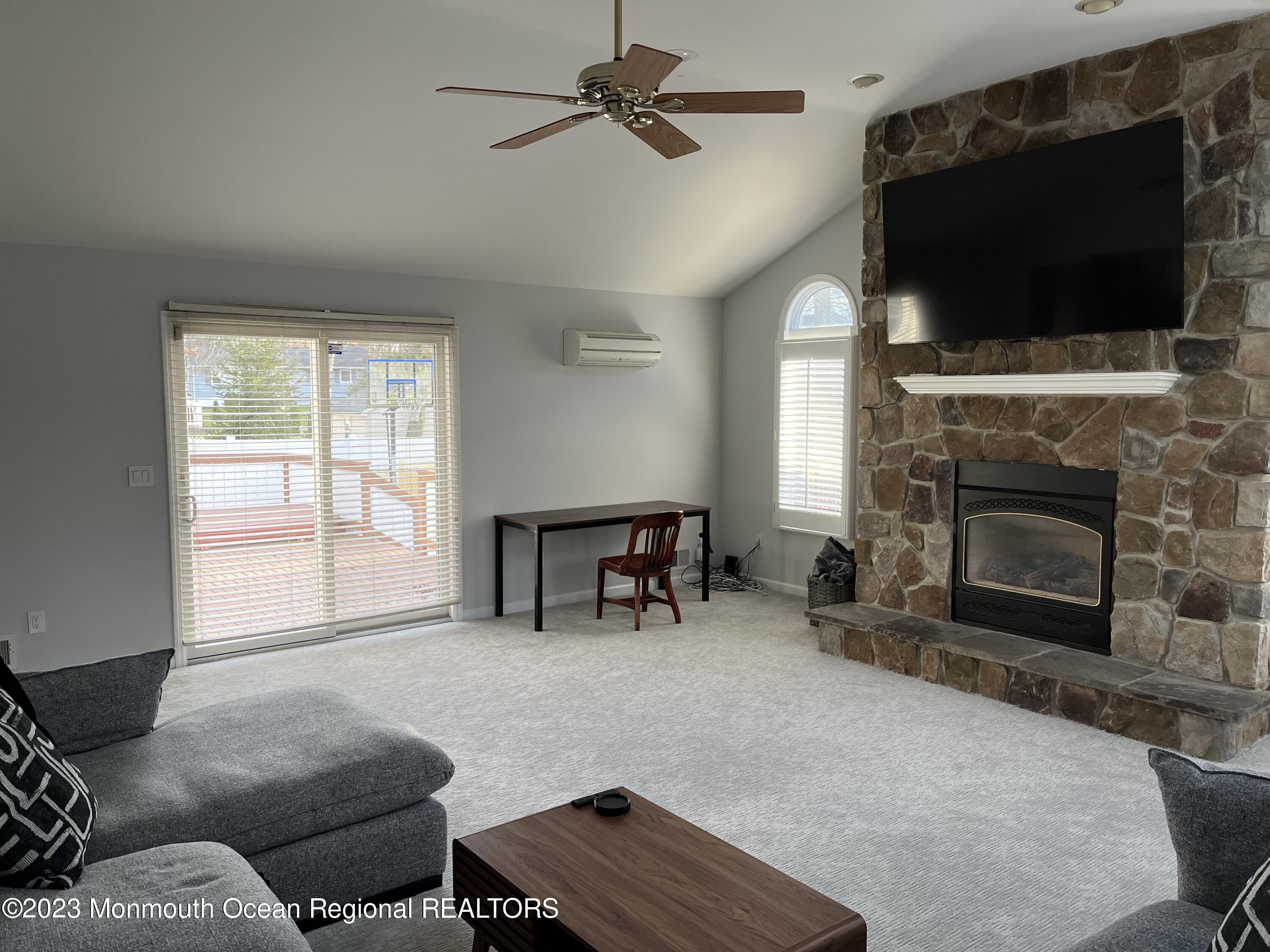 128 Whalepond Road Oakhurst, NJ 07755 - Photo 3 of 11 a living room with furniture and a flat screen tv