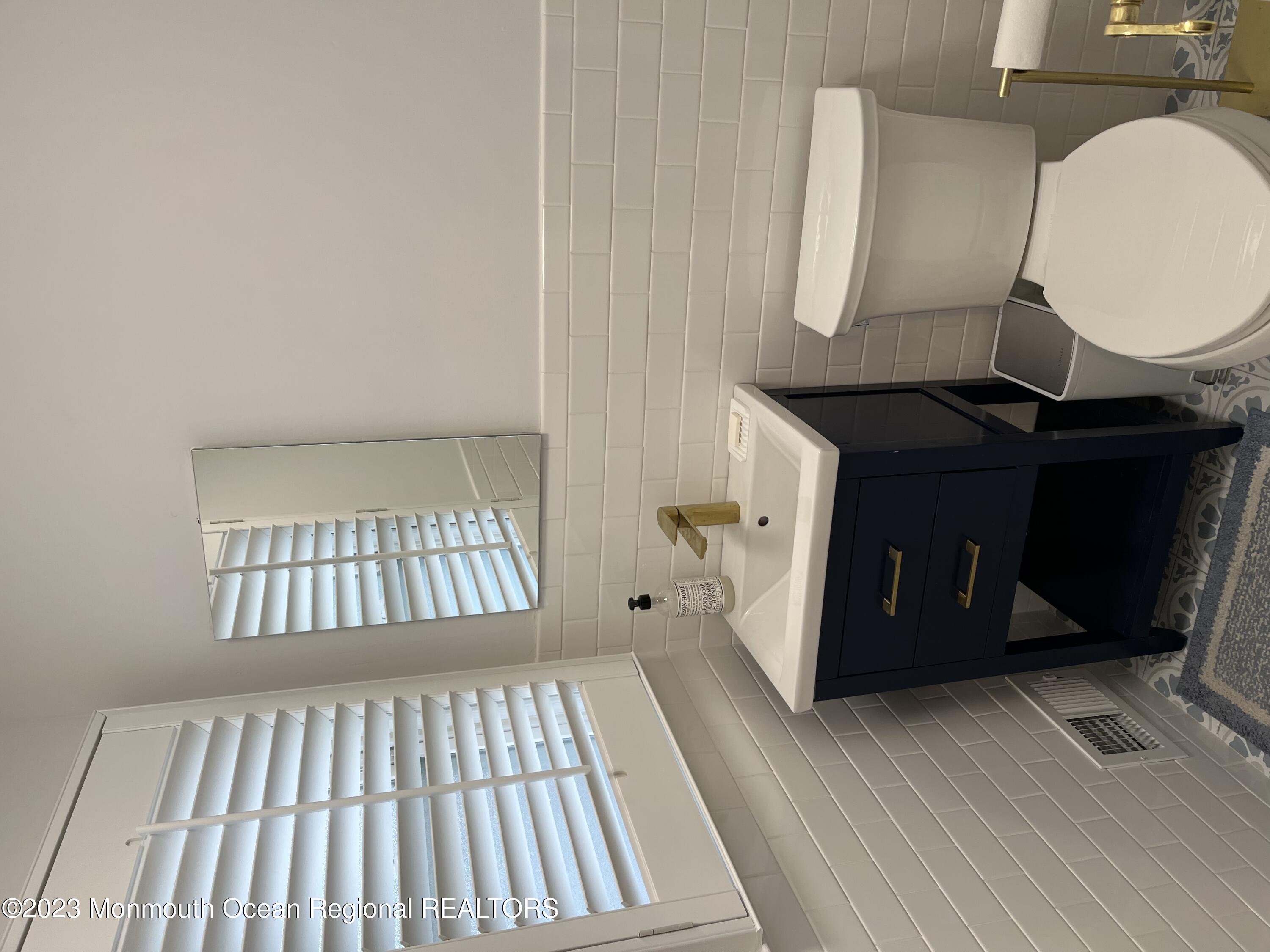 128 Whalepond Road Oakhurst, NJ 07755 - Photo 8 of 11 a living room with a wooden floor