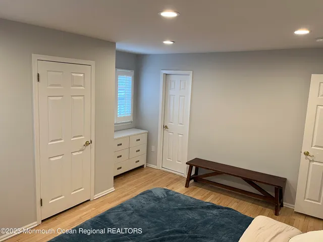 wooden floor with white walls and stairs