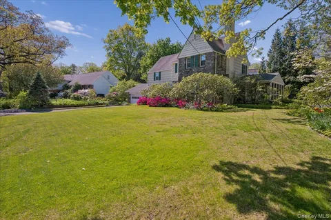 a front view of house with yard and trees